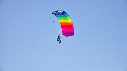 TAKE OFF Fehrbellin - Sportspringer mit buntem Fallchirm in der Luft